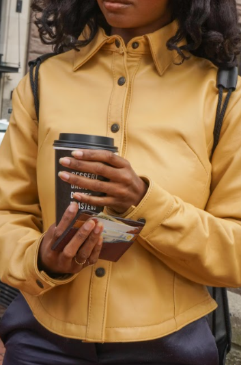 
                  
                    Load image into Gallery viewer, Woman holding a coffee and a Whittier Wallet. Whittier Wallet is made in the USA from repurposed materials.
                  
                